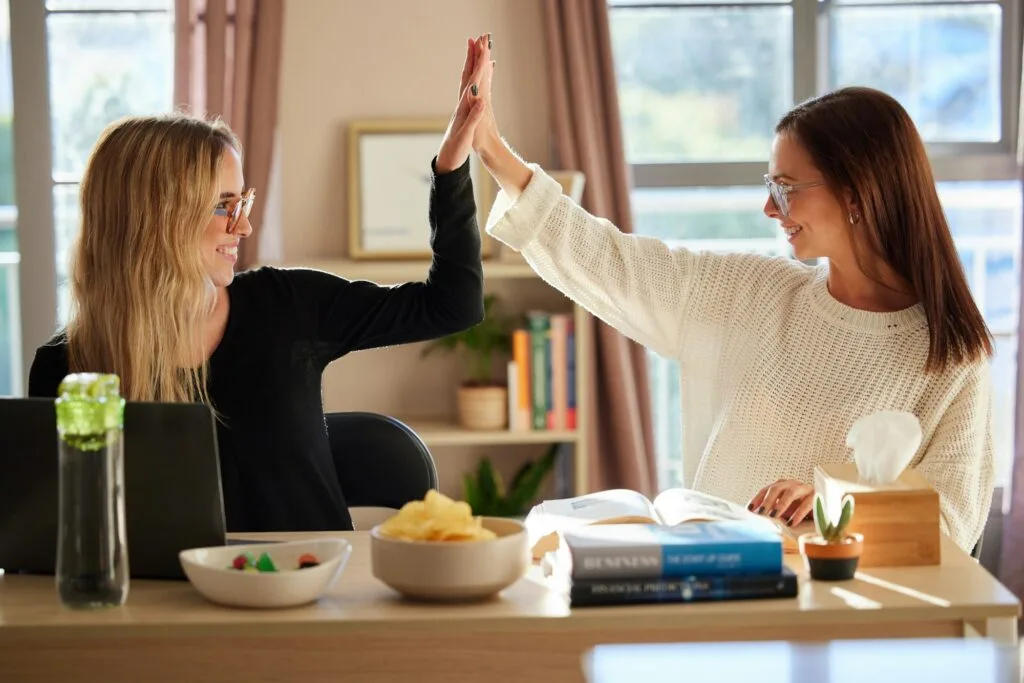 Talentivo.de Students, high five and young women study together with textbook, support and solidarity with elear, Online Marketing Students